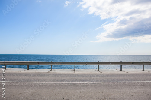 highway with fencing along the sea