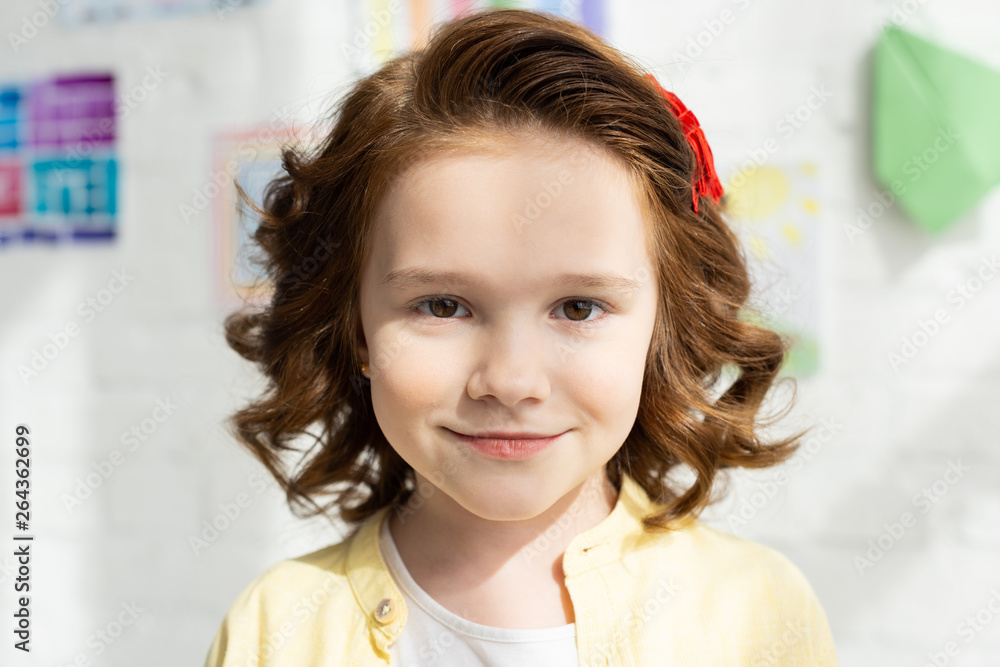 portrait of adorable smiling kid in yellow looking at camera portrait of adorable smiling kid in yellow looking at camera