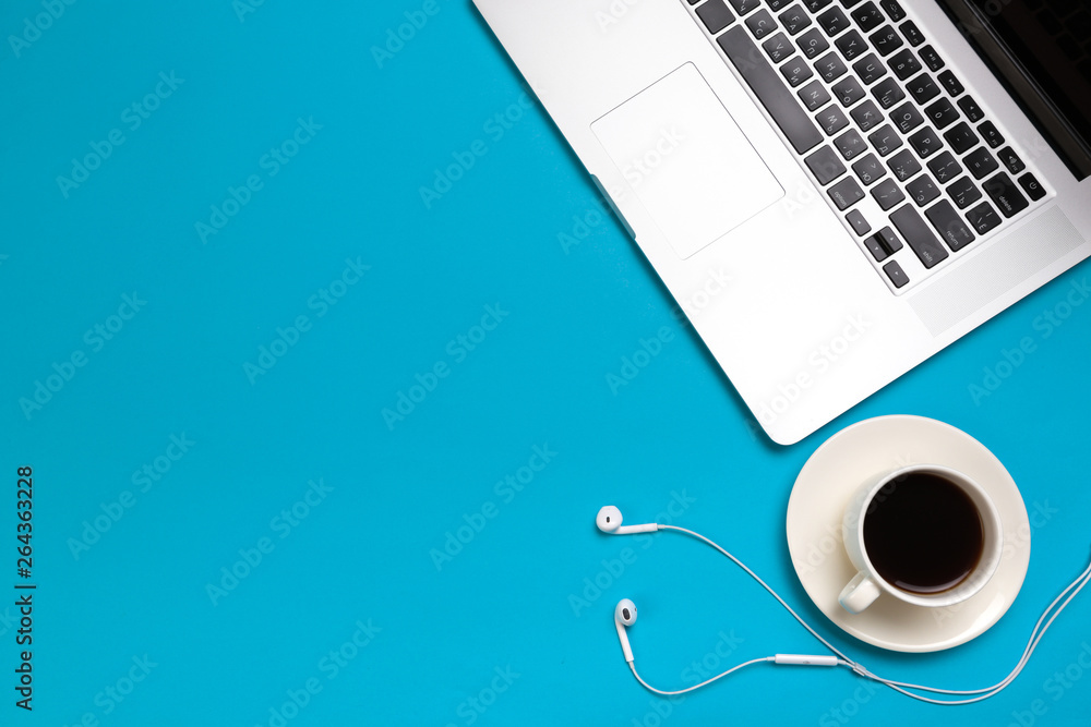 Office desk working space - Flat lay top view mockup photo of a working space with laptop, coffee cup and smartphone on blue pastel background. Pastel blue color copy space working desk concept. Office desk working space - Flat lay top view mockup photo of a working space with laptop, coffee cup and smartphone on blue pastel background. Pastel blue color copy space working desk concept.