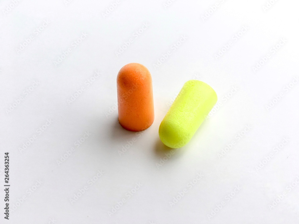 Orange and green ear plugs alignment isolated on white background Orange and green ear plugs alignment isolated on white background