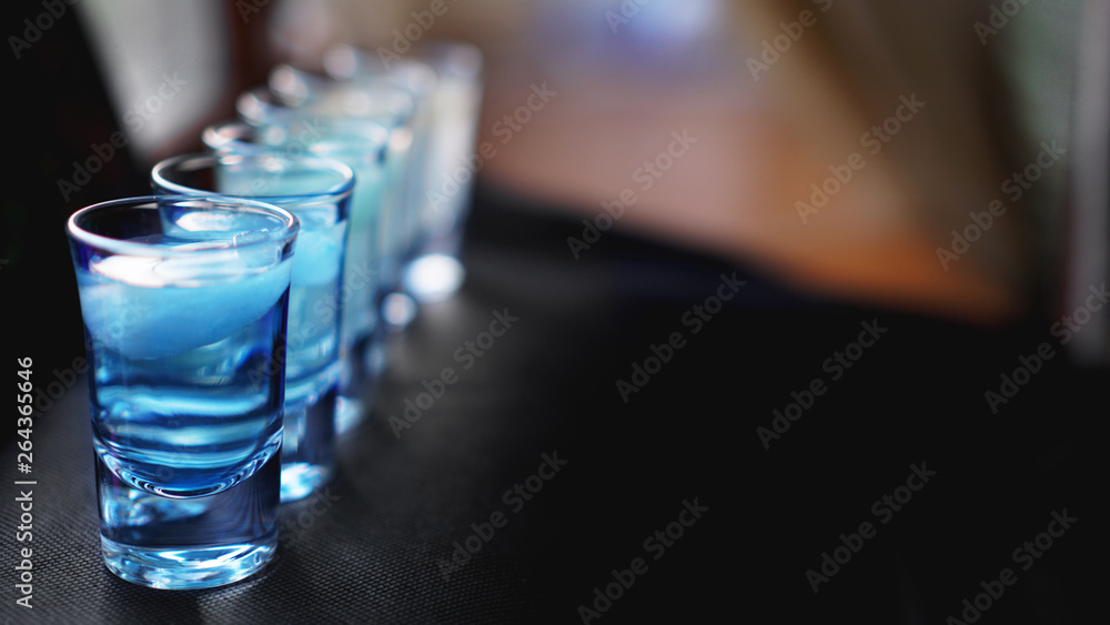 Glasses of vodka with ice. In bar - blurred background Glasses of vodka with ice. In bar - blurred background