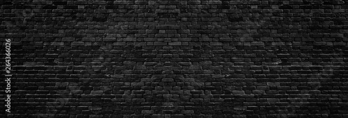 Black rough brick wall wide texture. Dark brickwork panoramic background