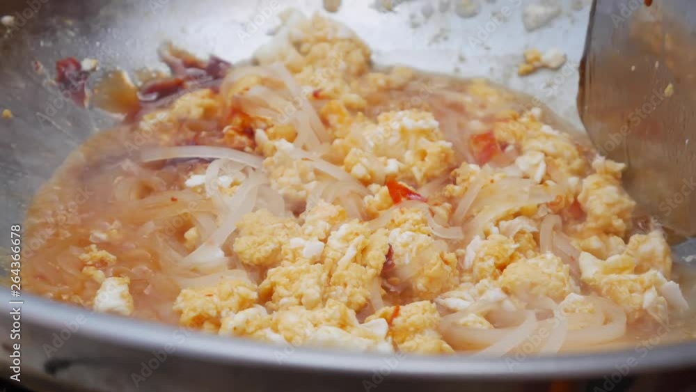 Noodles and egg fried in a wok. Step by step cooking pad thai. Thai cuisine. Closeup. 4k Noodles and egg fried in a wok. Step by step cooking pad thai. Thai cuisine. Closeup. 4k