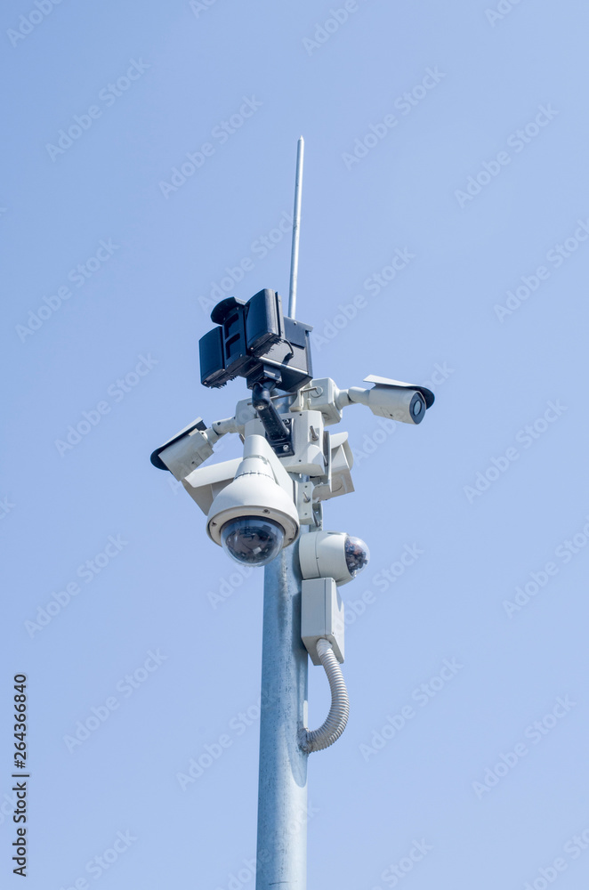 Many dome and bullet formats security cameras for video surveillance on pole in sky Many dome and bullet formats security cameras for video surveillance on pole in sky