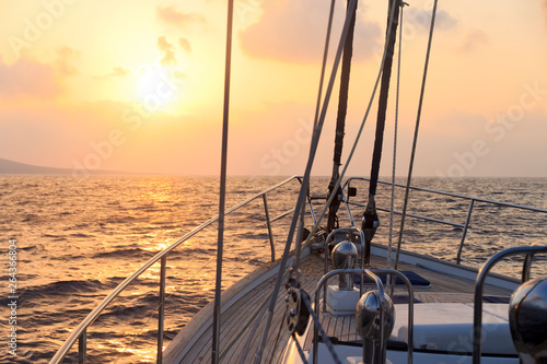Yacht sailing towards the sunset