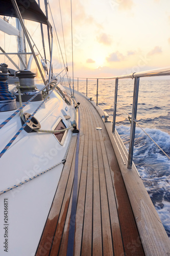 Yacht sailing towards the sunset © Plamen