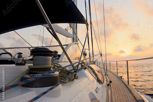 Yacht sailing towards the sunset