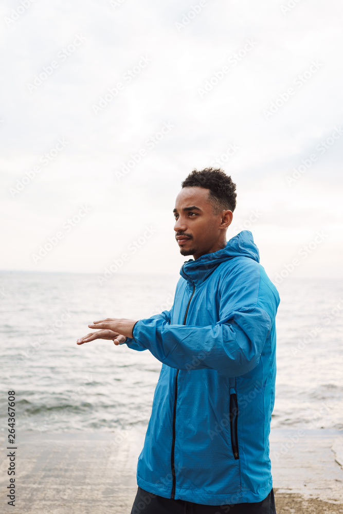 Handsome young african sports man outdoors at the beach sea walking make exercises. Handsome young african sports man outdoors at the beach sea walking make exercises.