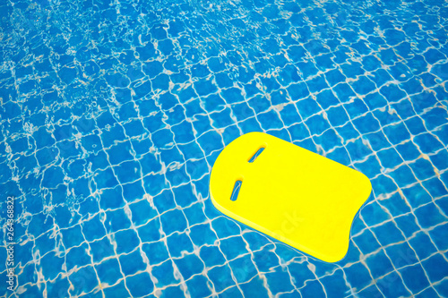 Yellow boogie foam board in swimming pool. photo