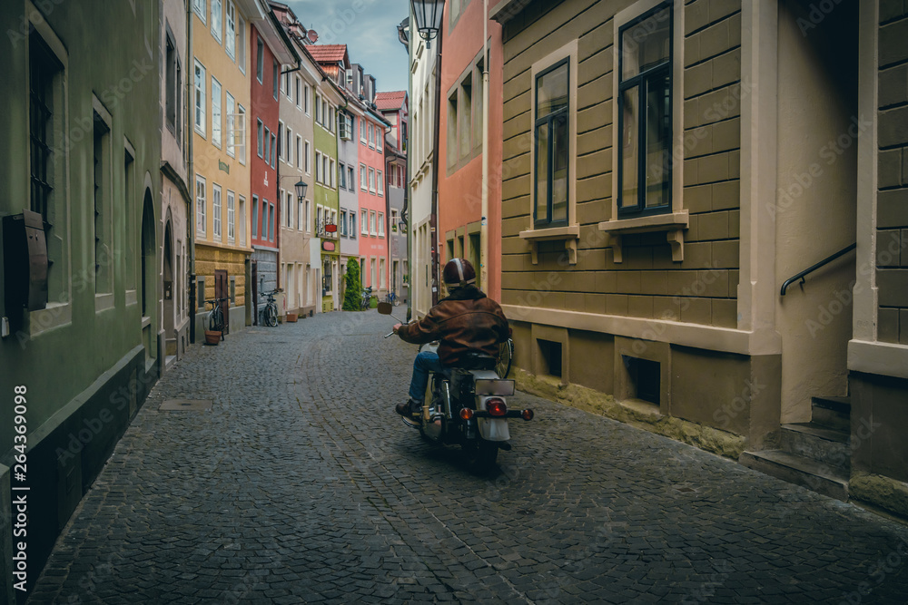 Motorcycle drives on the streets of the historic old town of Konstanz (Constance), a medieval city at Lake Constance (Bodensee), Germany