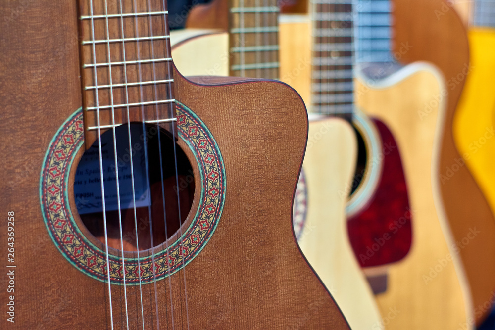 Many different colored acoustic guitars next to each other Stock Photo