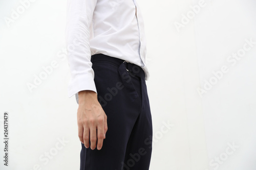 close-up of A handsome man in white formal shirt and black long trousers.