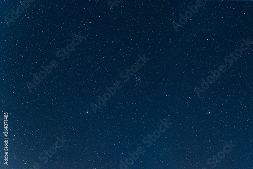 Night blue sky with stars. The texture of a blue sky with stars.