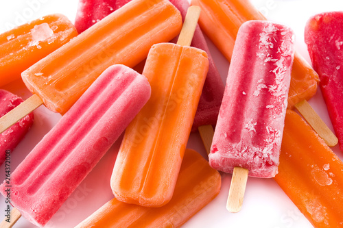 Orange and strawberry popsicles isolated on white background. photo