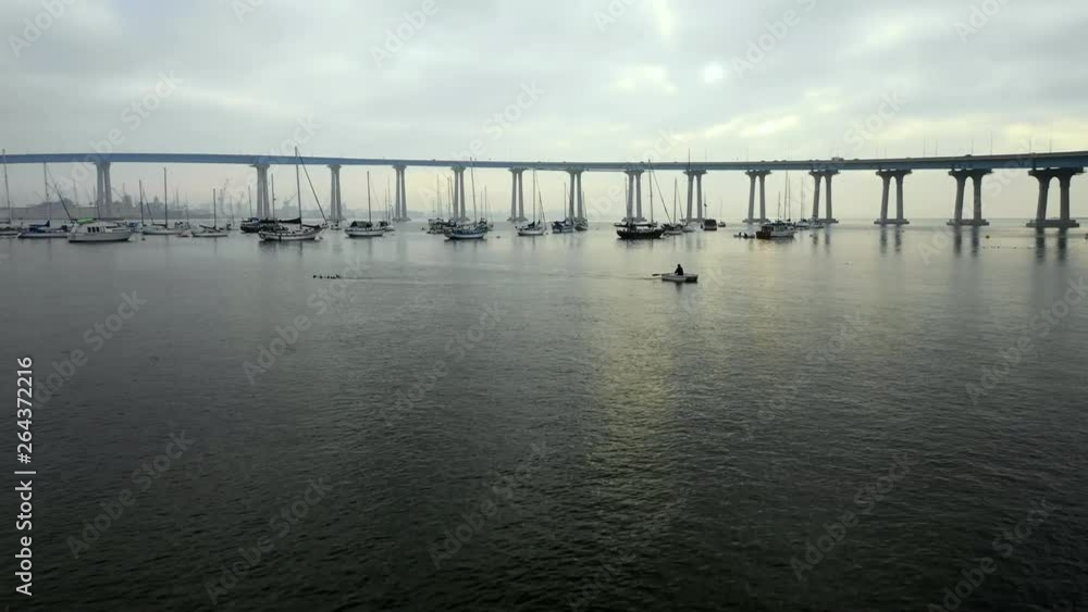 Aerial Forward: Boats Floating In Water Under Bridge On Cloudy Day in San Diego, United States of America Aerial Forward: Boats Floating In Water Under Bridge On Cloudy Day in San Diego, United States of America