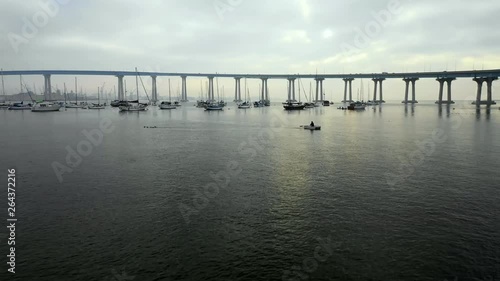 Wallpaper Mural Aerial Forward: Boats Floating In Water Under Bridge On Cloudy Day in San Diego, United States of America Torontodigital.ca