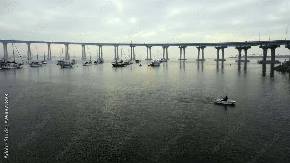 Aerial Lockdown: Boats Floating In Ocean Water Under Bridge On Cloudy Day in San Diego, United States of America Aerial Lockdown: Boats Floating In Ocean Water Under Bridge On Cloudy Day in San Diego, United States of America