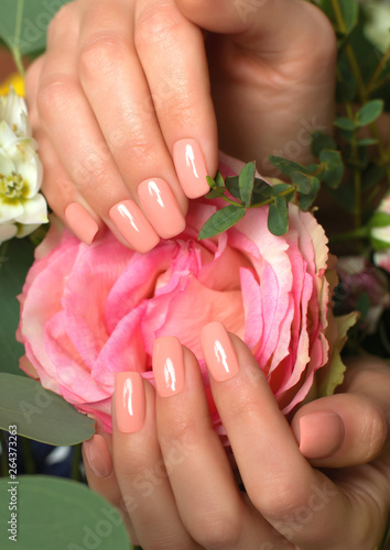 colorless manicure with a rose in his hand