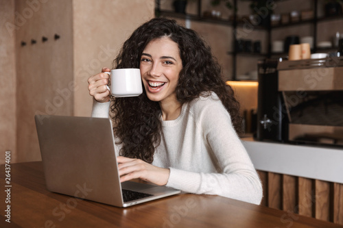 Excited happy woman using laptop computer