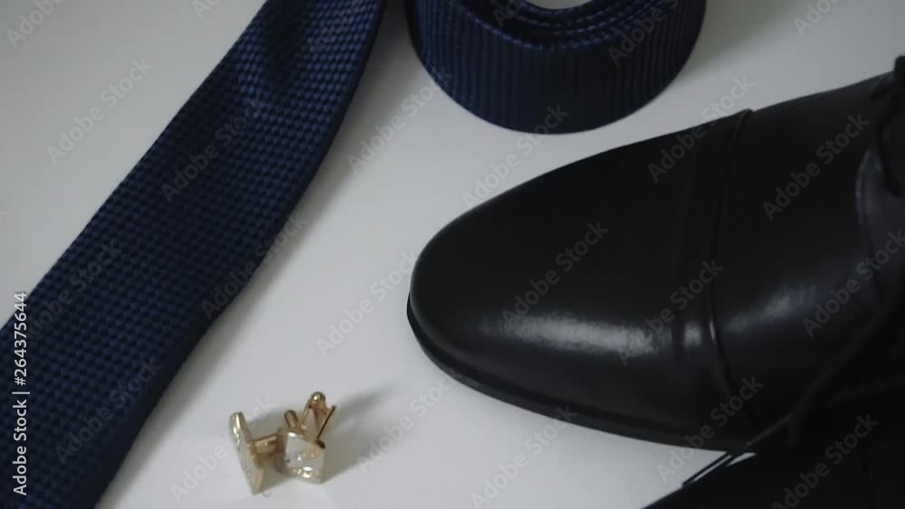 groom's accessories lying on a dark surface, wedding flatlay 1