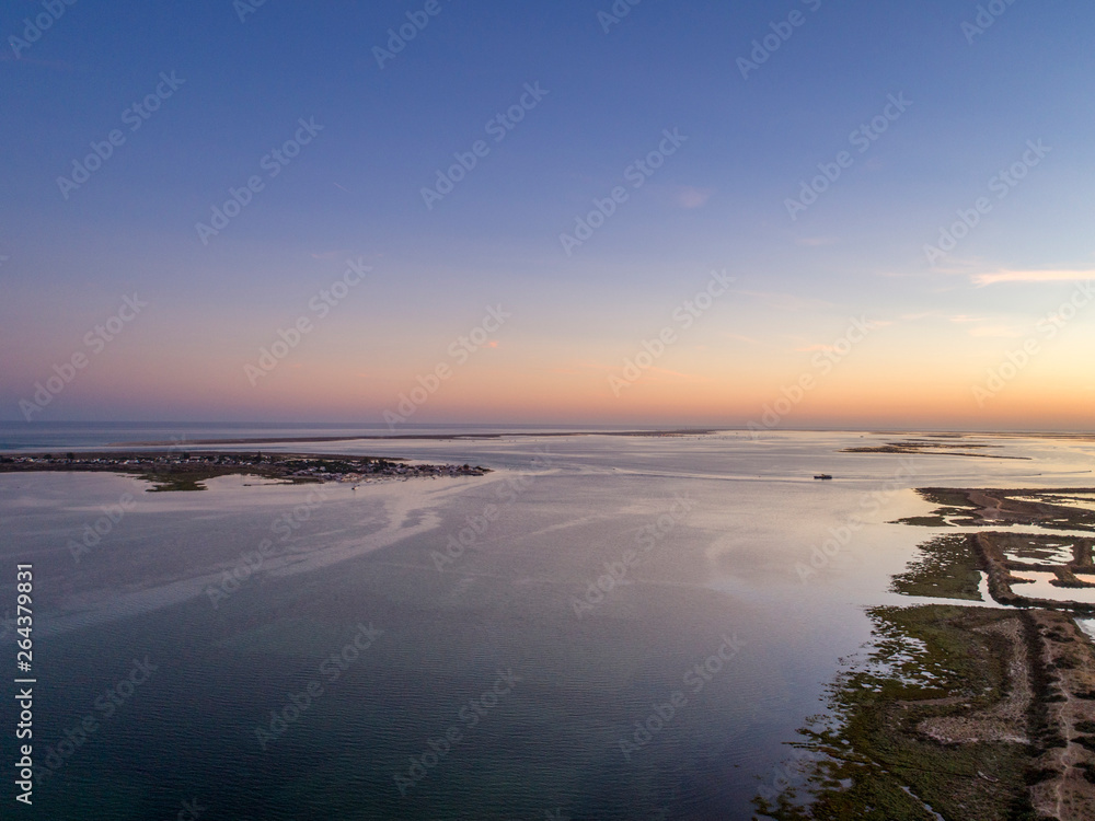 Algarve sunset seascape at Ria Formosa wetlands reserve, southern Portugal.