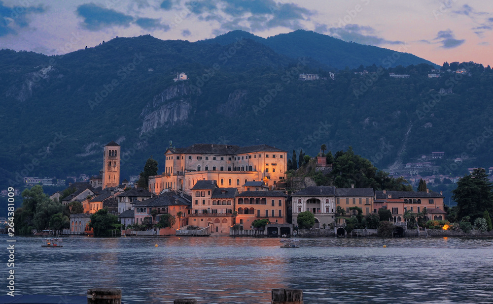 Orta Lake - Italy, suggestive view  of San Giulio island in the evening while the first lights come on