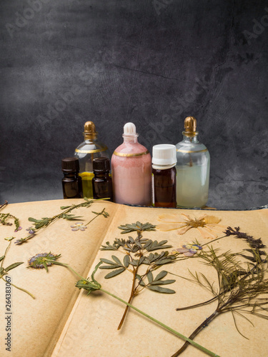 Aroma essential oil. Cosmetic Bottle among dried flowers, medicinal herbs variety. Natural cosmetic and skincare, herbal miscellany