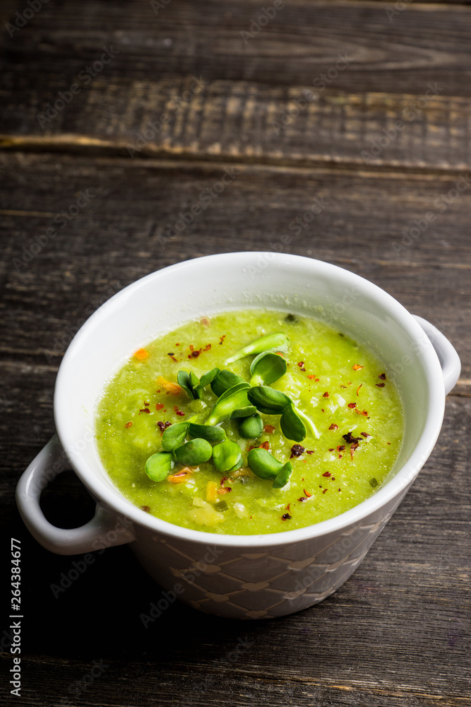 Hot green peas soup on the rustic background. Selective focus. Shallow depth of field. Hot green peas soup on the rustic background. Selective focus. Shallow depth of field.
