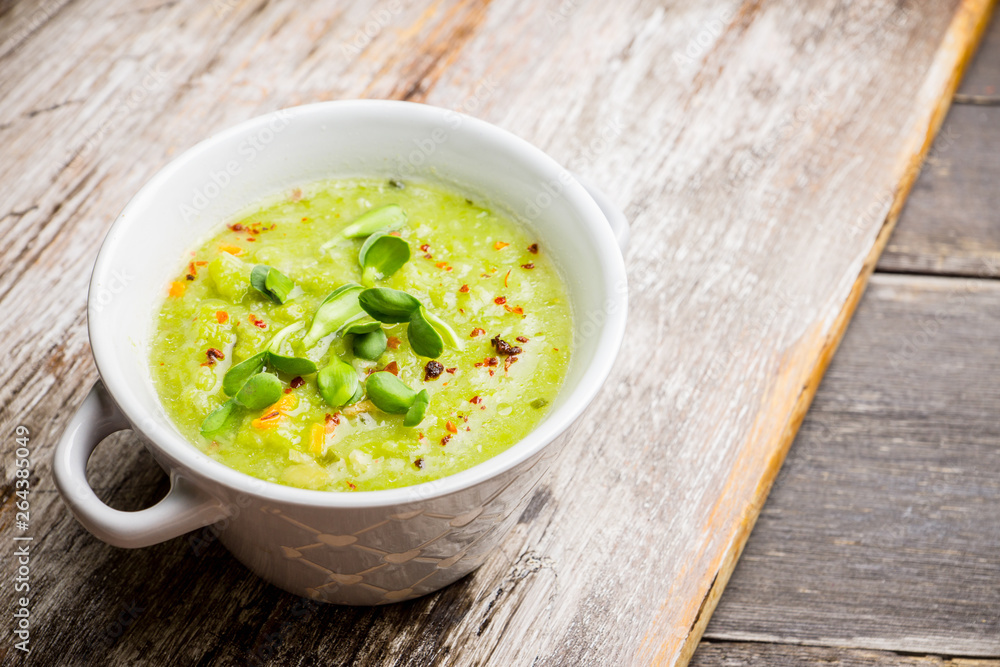 Hot green peas soup on the rustic background. Selective focus. Shallow depth of field. Hot green peas soup on the rustic background. Selective focus. Shallow depth of field.