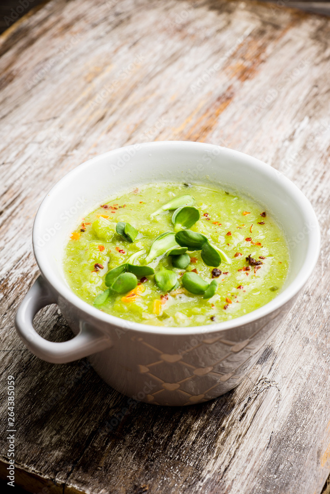 Hot green peas soup on the rustic background. Selective focus. Shallow depth of field. Hot green peas soup on the rustic background. Selective focus. Shallow depth of field.
