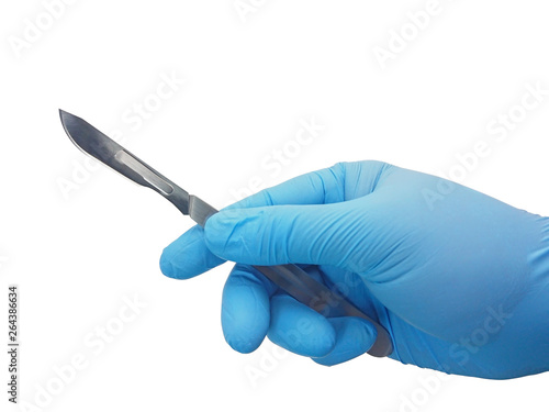 Hand of surgeon in blue medical glove holding a scalpel with blade isolated on white background with clipping path