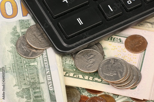 Calculator on banknotes with a pen and pencil. Limited depth of field