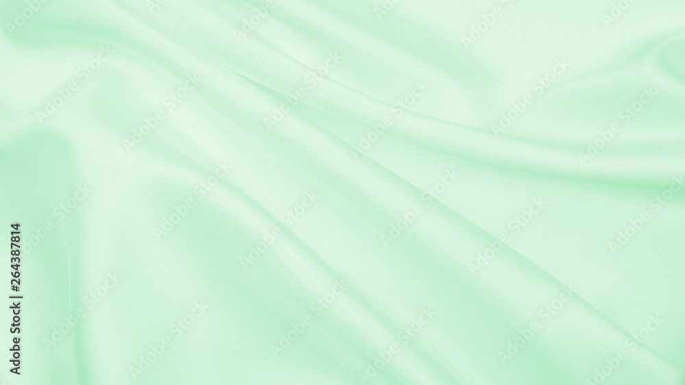 Smooth elegant green silk or satin luxury cloth texture as abstract background. Luxurious background design Smooth elegant green silk or satin luxury cloth texture as abstract background. Luxurious background design