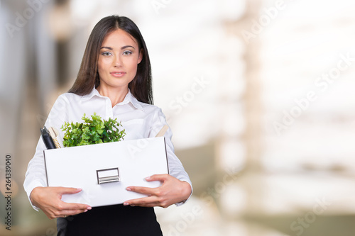 Young happy business woman with a box to move to a new office.