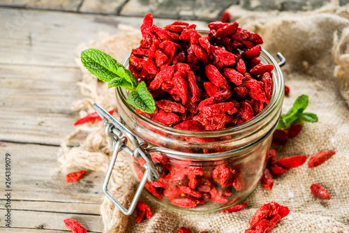 Konstfotografi Dried goji berries in little jar, wooden background copy space