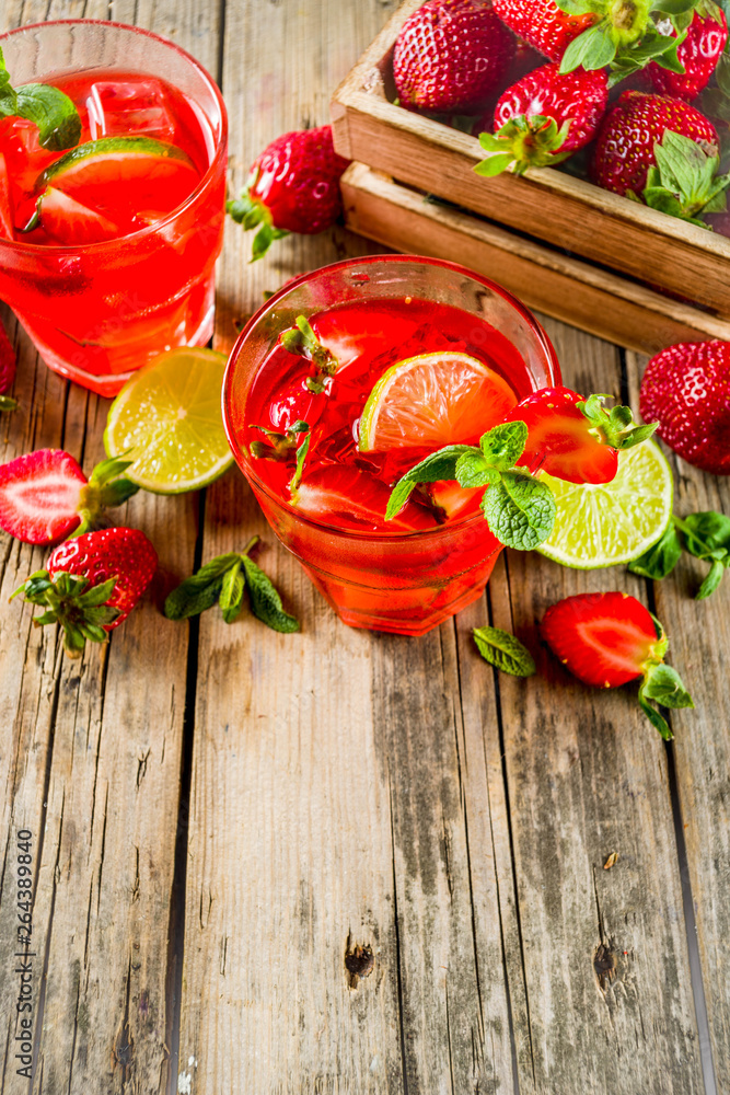 Homemade strawberry lemonade with lime and mint, rustic wooden background copy space Homemade strawberry lemonade with lime and mint, rustic wooden background copy space