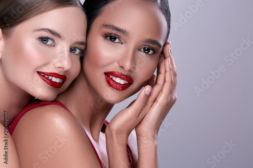 two happy girls with red lipstick  close-up portrait of two