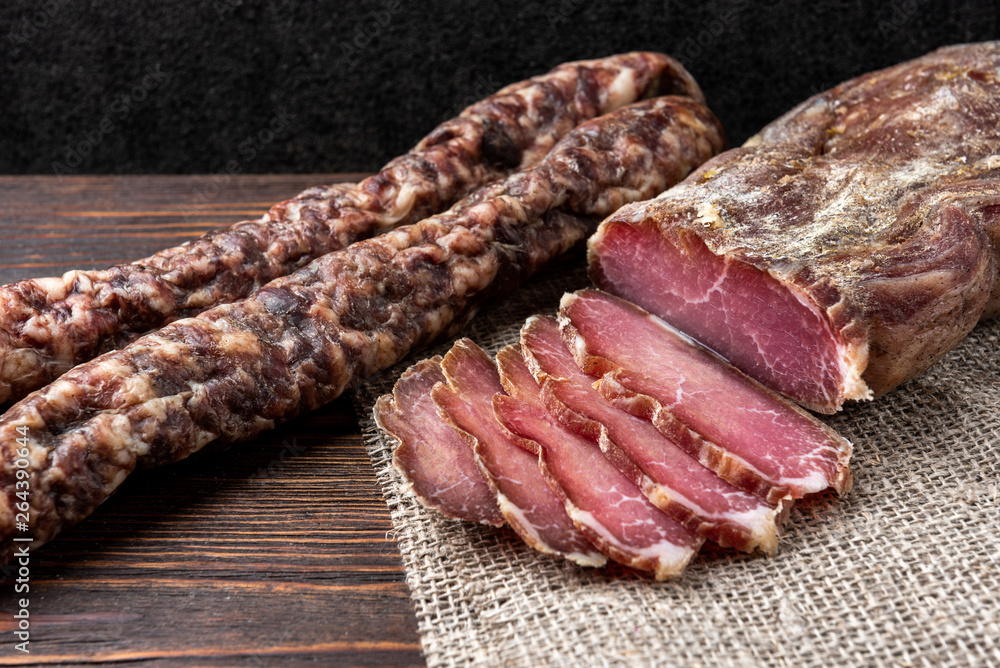 Dried pork meat on dark wooden background Dried pork meat on dark wooden background