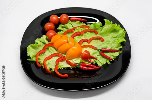 vegetables on a plate laid out in the shape of a scorpion 