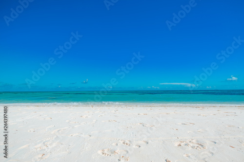 Empty tropical beach background. Horizon with sky and white sand. Minimalism tropical beach concept