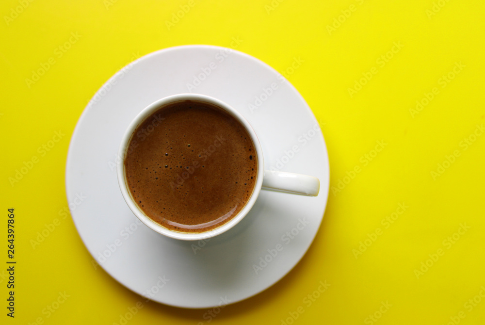 Fototapeta premium Cup of Turkish coffee on yellow color background