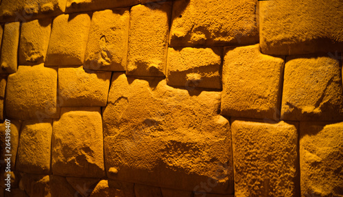 View to Twelve-angled stone aka Hatun Rumiyoc as a part of a wall of the palace of the Archbishop of Cuzco, Peru photo