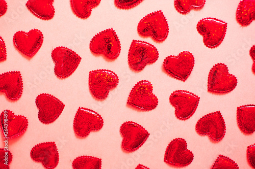 A lot of sparkling hearts together on coral background