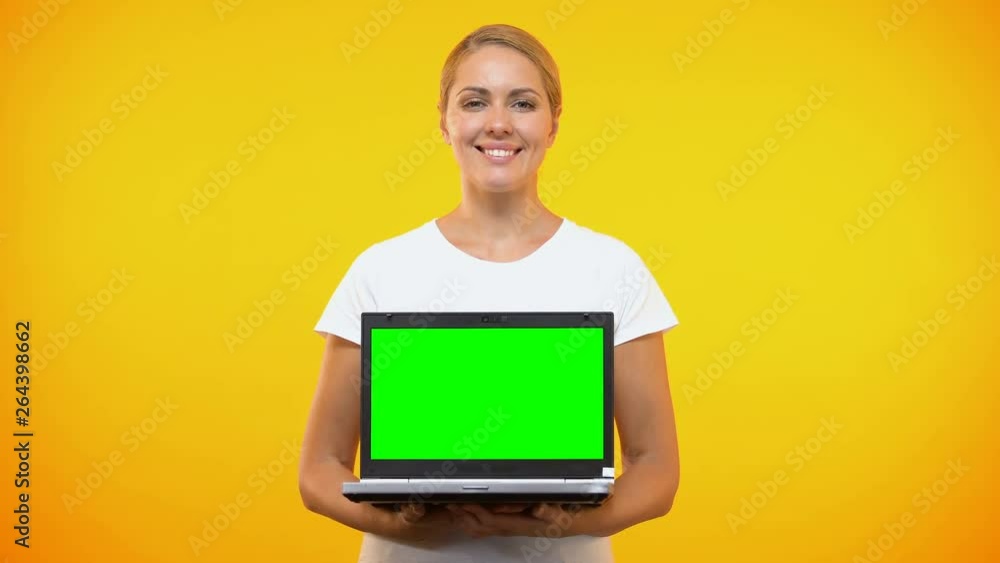 Smiling pretty lady holding laptop green screen, online presentation, freelance Smiling pretty lady holding laptop green screen, online presentation, freelance