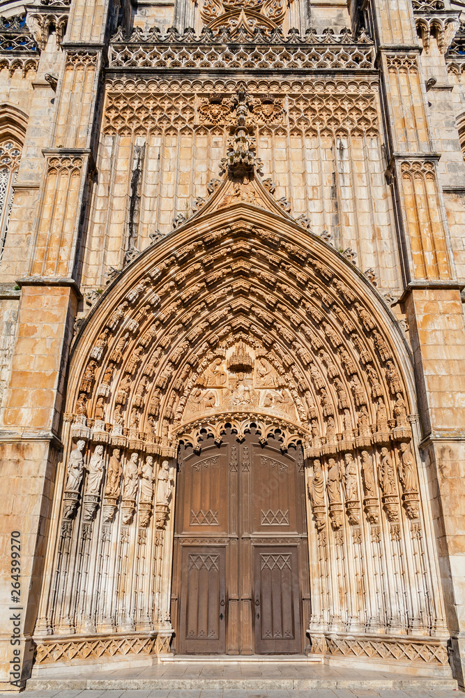 Batalha, Portugal. Portal of Batalha Abbey aka Monastery of Santa Maria da Vitoria, with tympanum, archivolts and lintel and other Gothic and Manuelino elements.