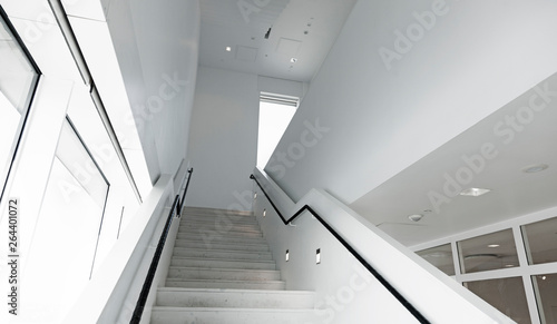 white stairwell with black railing