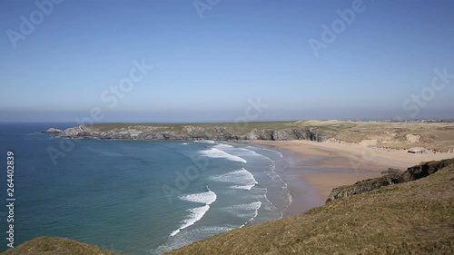 Holywell Bay North Cornwall with waves beach and coast on a beautiful day
