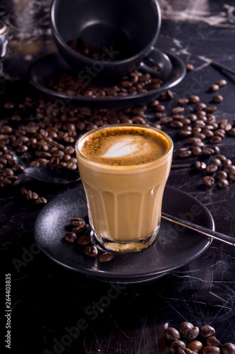 cup of coffee with beans on a black background