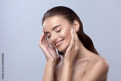 happy woman touching her face, girl smilling with close eyes, healthy happy face photo