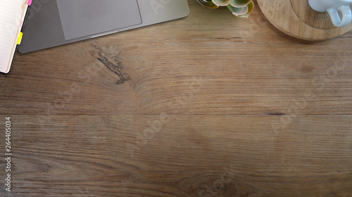 Wood office desk table with laptop office supplies and copy space.
